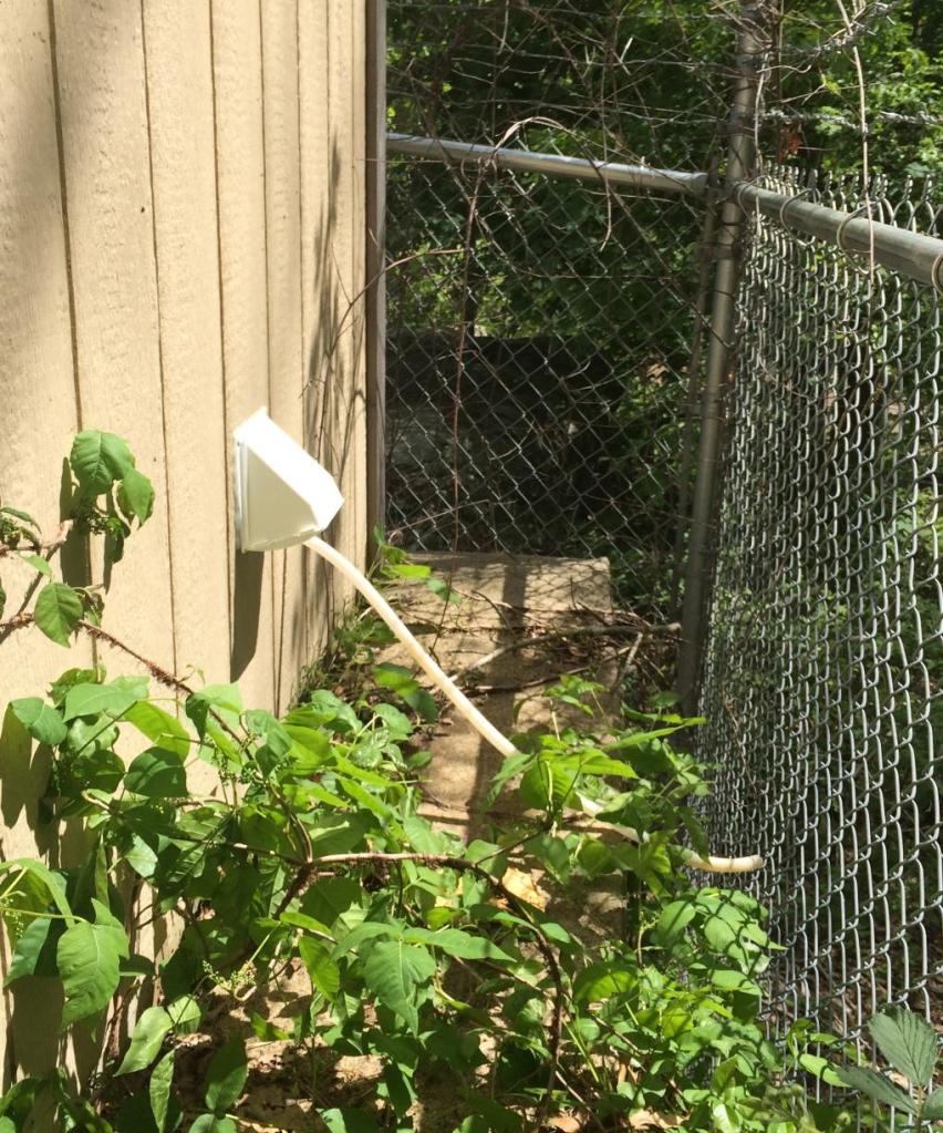The A/C's hot air vent on the back of the shelter, and the condensate drain.